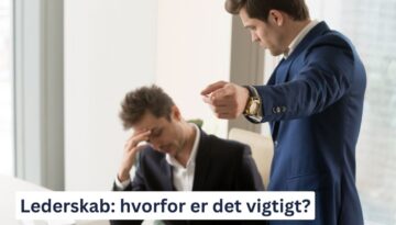 Billedet viser en kontorsituation, hvor en mand i en blå jakkesæt peger bestemt mod noget, mens en anden mand, der ser stresset og bekymret ud, sidder med hovedet i hænderne. Nederst på billedet står teksten: "Lederskab: hvorfor er det vigtigt?"